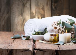spa massage setting, product, oil on wooden background